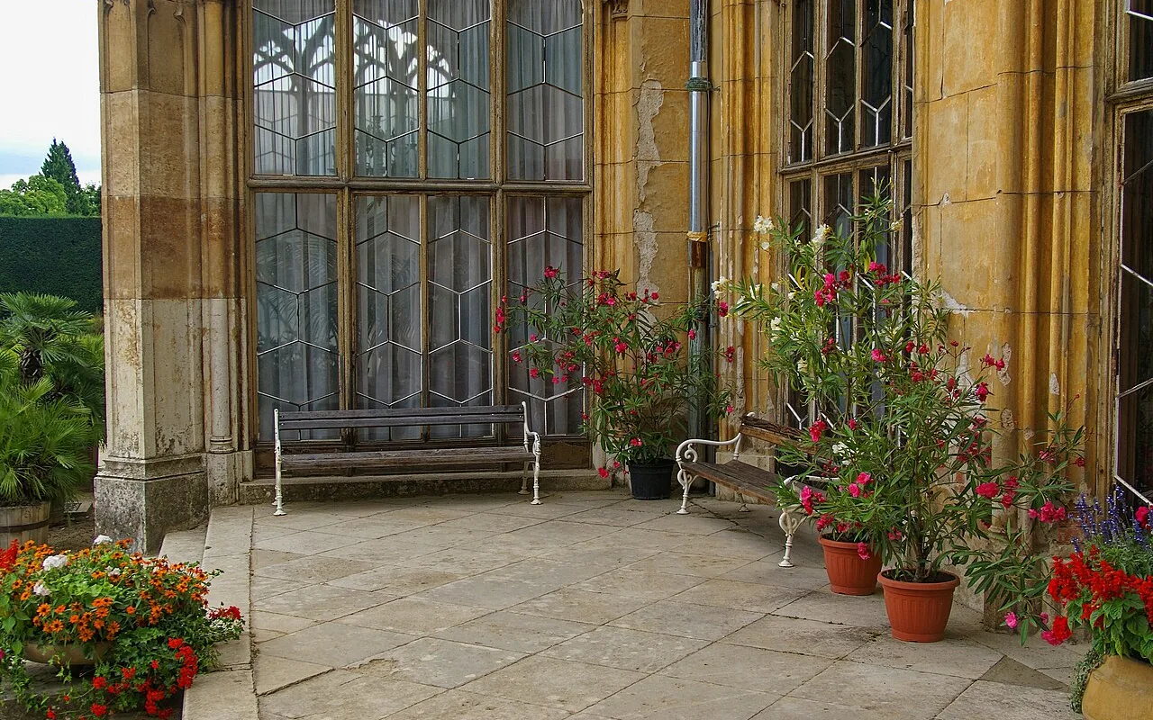 The chateau loggia with potted flowers looking onto the park